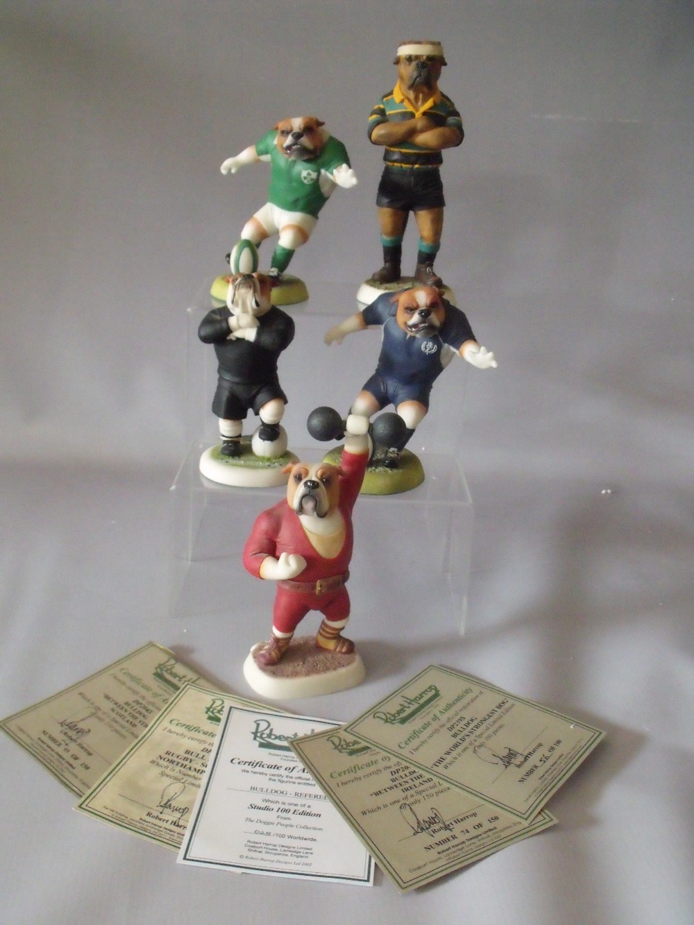 FOUR BOXED ROBERT HARROP SPECIAL LIMITED EDITION DOG FIGURES, comprising three Bulldog rugby themed