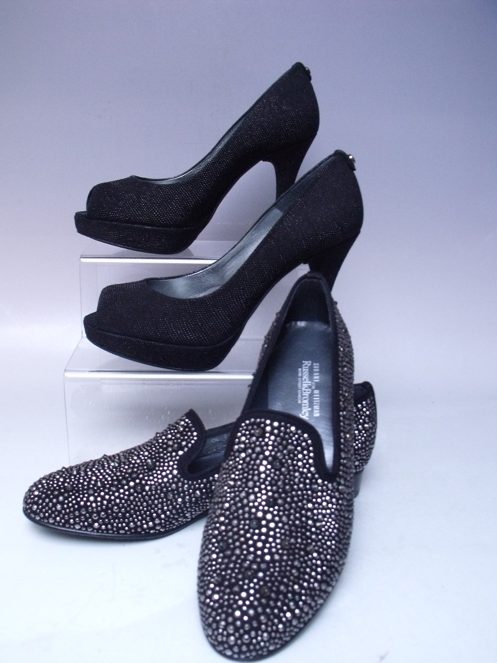 TWO PAIRS OF STUART WEITZMAN FOR RUSSELL BROMLEY SHOES, comprising a pair of black peep toed