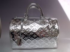 A LOUIS VUITTON SILVER MONOGRAM VERNIS SPEEDY BAG, with double top handle, padlock and key fob, dust