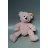 A STEIFF PINK CHILDS TEDDY BEAR, with button and orange tag, H 30 cm