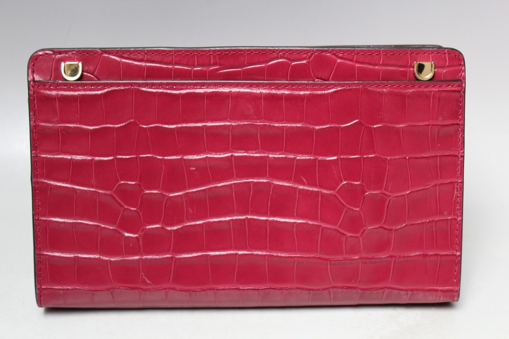 A MICHAEL KORS FUSHIA EMBOSSED LEATHER CROSS BODY CLUTCH BAG, single open pocket to reverse of bag - Image 4 of 4