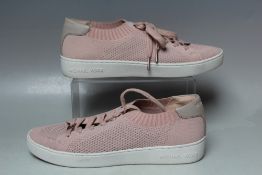 A PAIR OF MICHAEL KORS PALE PINK LACE UP TRAINERS. textile 'knit' effect uppers, textile sole, US