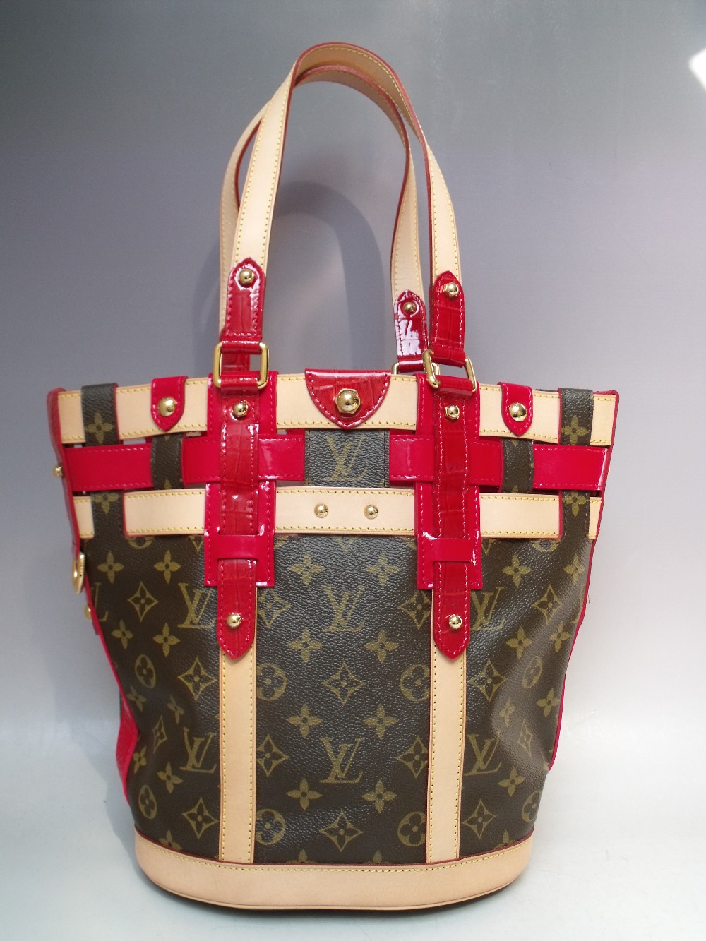 A LOUIS VUITTON RUBIS SALINA PM BAG, with double top handles, natural leather trim and red patent