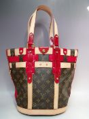 A LOUIS VUITTON RUBIS SALINA PM BAG, with double top handles, natural leather trim and red patent