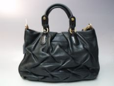 A SMALL SMYTHSON OF BOND STREET BLACK LEATHER HAND BAG, with gold tone hardware, twin handle with