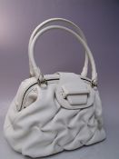 A SMALL SMYTHSON OF BOND STREET CREAM LEATHER HAND BAG, with gold tone hardware, twin handle with