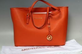 A MICHAEL KORS SAFFIANO LEATHER LARGE TOTE BAG IN BURNT ORANGE, open top with taupe logo fabric