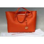 A MICHAEL KORS SAFFIANO LEATHER LARGE TOTE BAG IN BURNT ORANGE, open top with taupe logo fabric