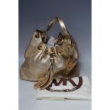 A MICHAEL KORS 'CAMDEN' LARGE LEATHER DRAWSTRING BAG IN GOLD, textured finish, with gold tone