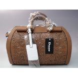 A DUNE OF LONDON BARREL BAG, in tan and white leather with a cut out design, twin handles and