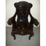 AN EBONITED CARVED ORIENTAL STYLE CHAIR.