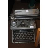 A VINTAGE IMPERIAL TYPEWRITER TOGETHER WITH A HARD SUITCASE