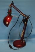 A RED ANGLEPOISE LAMP