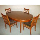 A TEAK EXTENDING OVAL DINING SET WITH FOUR CHAIRS