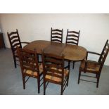 AN OAK DROPLEAF DINING SET COMPRISING A TABLE AND SIX CHAIRS INCLUDING TWO CARVERS
