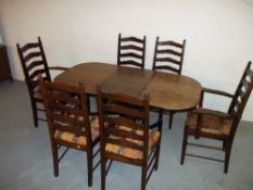 AN OAK DROPLEAF DINING SET COMPRISING A TABLE AND SIX CHAIRS INCLUDING TWO CARVERS