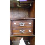 AN EDWARDIAN MINIATURE TWO DRAWER CABINET
