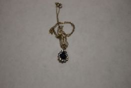 A 9 CT GOLD BLUE STONE SET PENDANT ON CHAIN