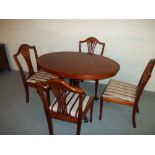 AN OVAL SMALL DINING SET WITH FOUR CHAIRS