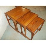 A RETRO TEAK G-PLAN NEST OF THREE TABLES