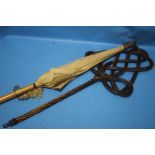 A CARPET BEATER AND A VINTAGE PARASOL