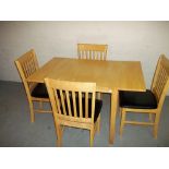 A MODERN DROPLEAF DINING TABLE AND FOUR CHAIRS