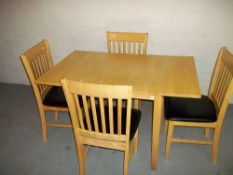 A MODERN DROPLEAF DINING TABLE AND FOUR CHAIRS