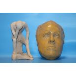 AN ART POTTERY DEATH MASK AND A FIGURE