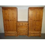 A SOLID PINE THREE PIECE BEDROOM SET TO INCLUDE TWO WARDROBES AND A FOUR + TWO DRAWER CHEST