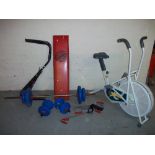 A SELECTION OF EXERCISE EQUIPMENT TO INCLUDE AN EXERCISE BIKE, WEIGHTS BENCH AND BARBALL / DUMBELL