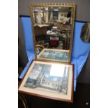 A GILT FRAMED MIRROR, 98 X 67 CM TOGETHER WITH A FRAMED AND GLAZED PRINT OF A STREET SCENE