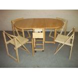A MODERN DROPLEAF STORE AWAY DINING SET WITH FOUR FOLDING CHAIRS.