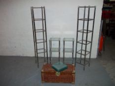 FOUR GLASS SHELVING UNITS AND A WICKER STORAGE BASKET / TRUNK (5)