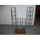 FOUR GLASS SHELVING UNITS AND A WICKER STORAGE BASKET / TRUNK (5)