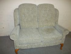 A CLEAN FABRIC MODERN TWO SEATER HIGH BACKED SOFA