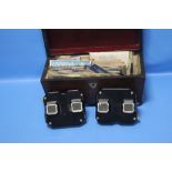 TWO VIEWMASTERS AND SLIDES CONTAINED IN A WOODEN CASKET AND ANOTHER BAKELITE VIEWMASTER