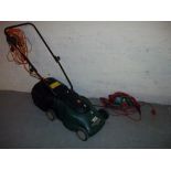 A BLACK AND DECKER ELECTRIC LAWN MOWER AND A GARDEN STRIMMER.