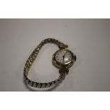 A VINTAGE LADIES 9 CT GOLD CASED WRIST WATCH ON A PLATED EXPANDING STRAP
