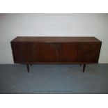 A VINTAGE TEAK SIDEBOARD WITH SLIDING DOORS.