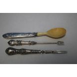 TWO SILVER PICKLE FORKS AND A SILVER HANDLED HORN SPOON (3)