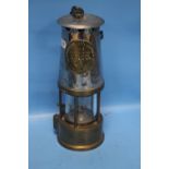 A VINTAGE MINERS LAMP MADE BY THE PROTECTOR LAMP AND LIGHTNING CO. LTD. OF ECCLES, MANCHESTER,