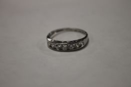 A LADIES PLATINUM SEVEN STONE (CZS) RING