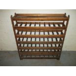 A SOLID MAHOGANY BOTTLE STORAGE RACK.