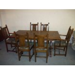 AN OLD CHARM OAK DINING SET A TABLE AND SIX CHAIRS INCLUDING TWO CARVERS.