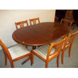 A YEW OVAL EXTENDING TABLE AND SIX CHAIRS.