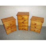 THREE SOLID PINE CHEST OF DRAWERS TO COMPRISE A FOUR DRAWER AND TWO THREE DRAWER BEDSIDES.