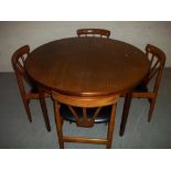 A TEAK EXTENDING TABLE AND FOUR CHAIRS.