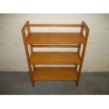 A FOLD AWAY WOODEN BOOK SHELF.