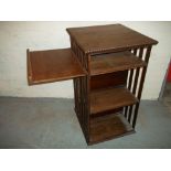 AN ANTIQUE OAK ROTATING TYPE BOOKSHELF.