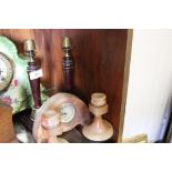 A PAIR OF BRASS AND TREEN CANDLESTICKS TOGETHER WITH AN ONYX CLOCK WITH MATCHING CANDLESTICKS